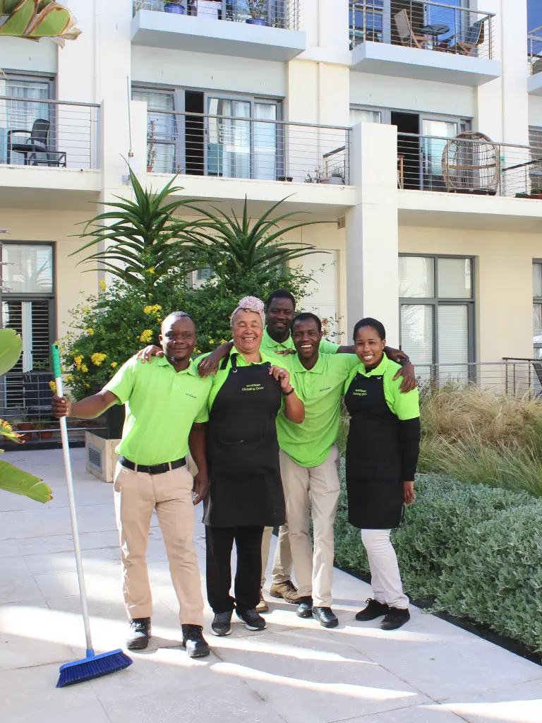 group of happy cleaners in courtyard