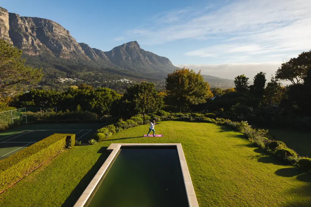 senior lady doing yoga on lawn in cape town