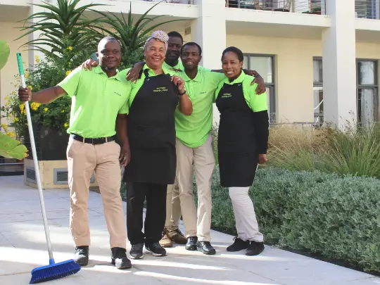 cleaning team smiling happily at the camera